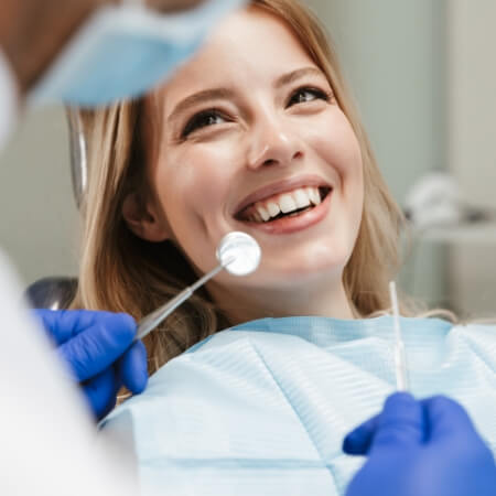 Smiling dental patient in dentistry treatment room