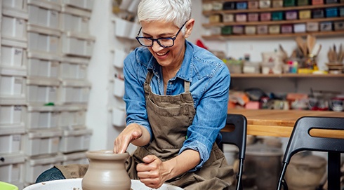 Woman smiling while working in pottery class