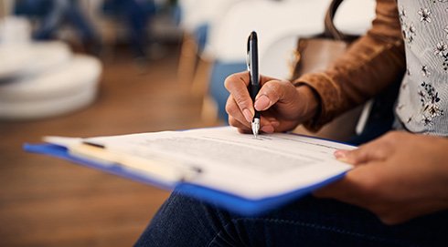 Patient in Novi filling out paperwork for teeth whitening