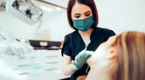 Dentist looking at patient's teeth