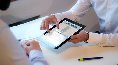 Patient reviewing dental insurance on tablet