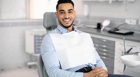 Man smiling while sitting in treatment chair