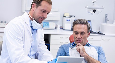 a dentist consulting with his patient