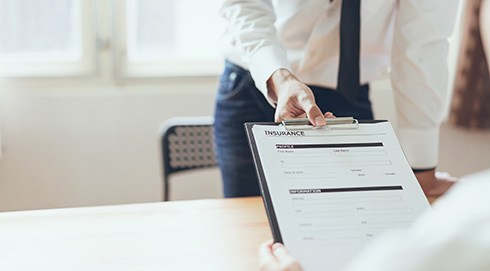 an empty dental insurance form on a clipboard