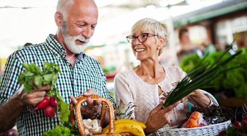 an older couple shopping for healthy groceries